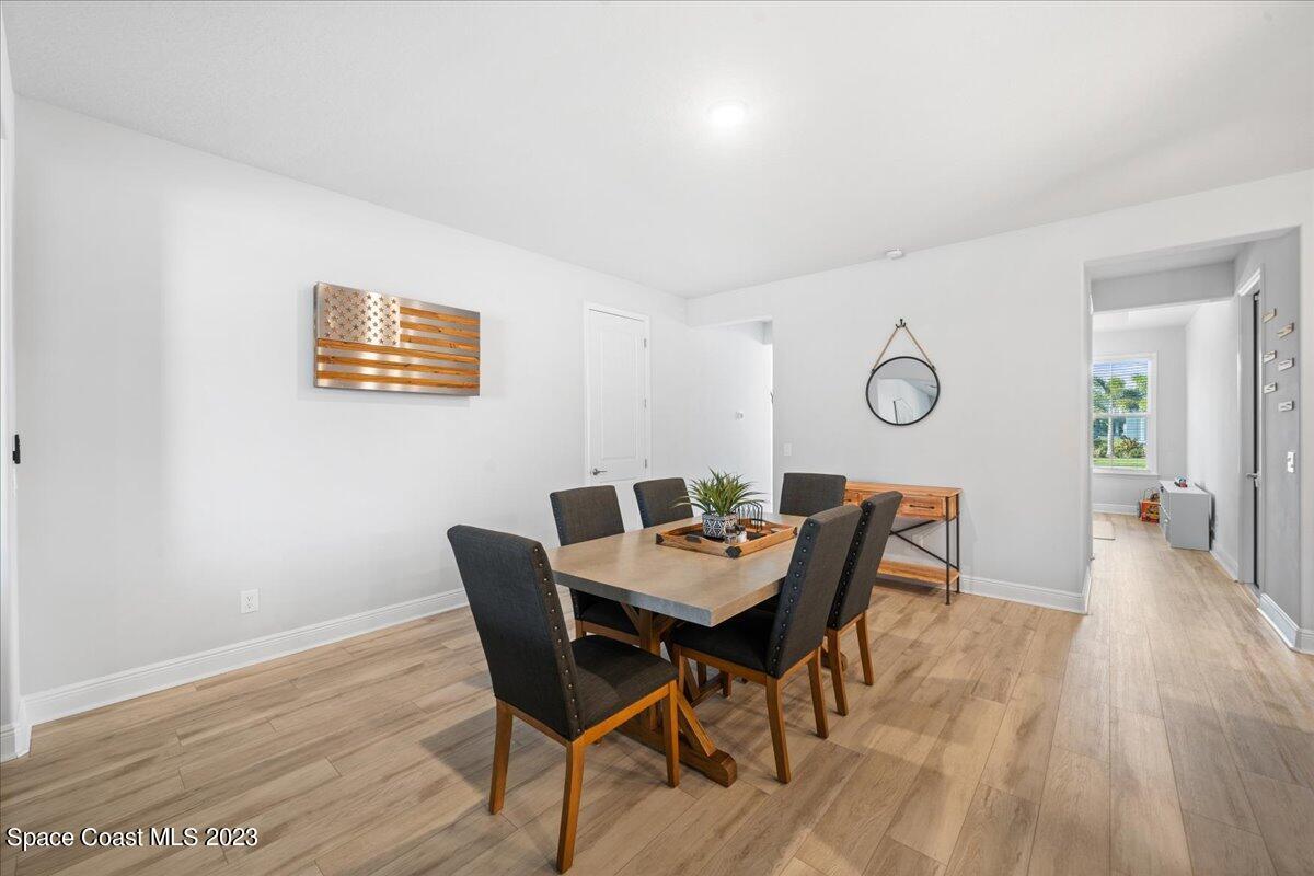 1582 Killian Drive Palm Bay, FL 32905 - Photo 6 of 37 a view of a dining room with furniture and wooden floor