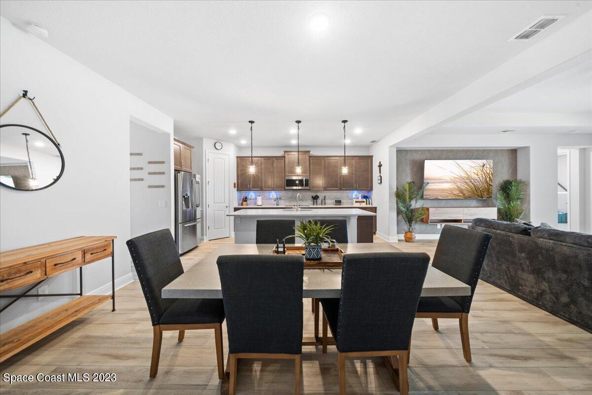 1582 Killian Drive Palm Bay, FL 32905 - Photo 7 of 37 a dining room with furniture a window and a kitchen view
