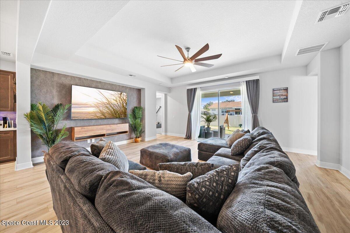 1582 Killian Drive Palm Bay, FL 32905 - Photo 8 of 37 a living room with furniture ceiling fan and a window