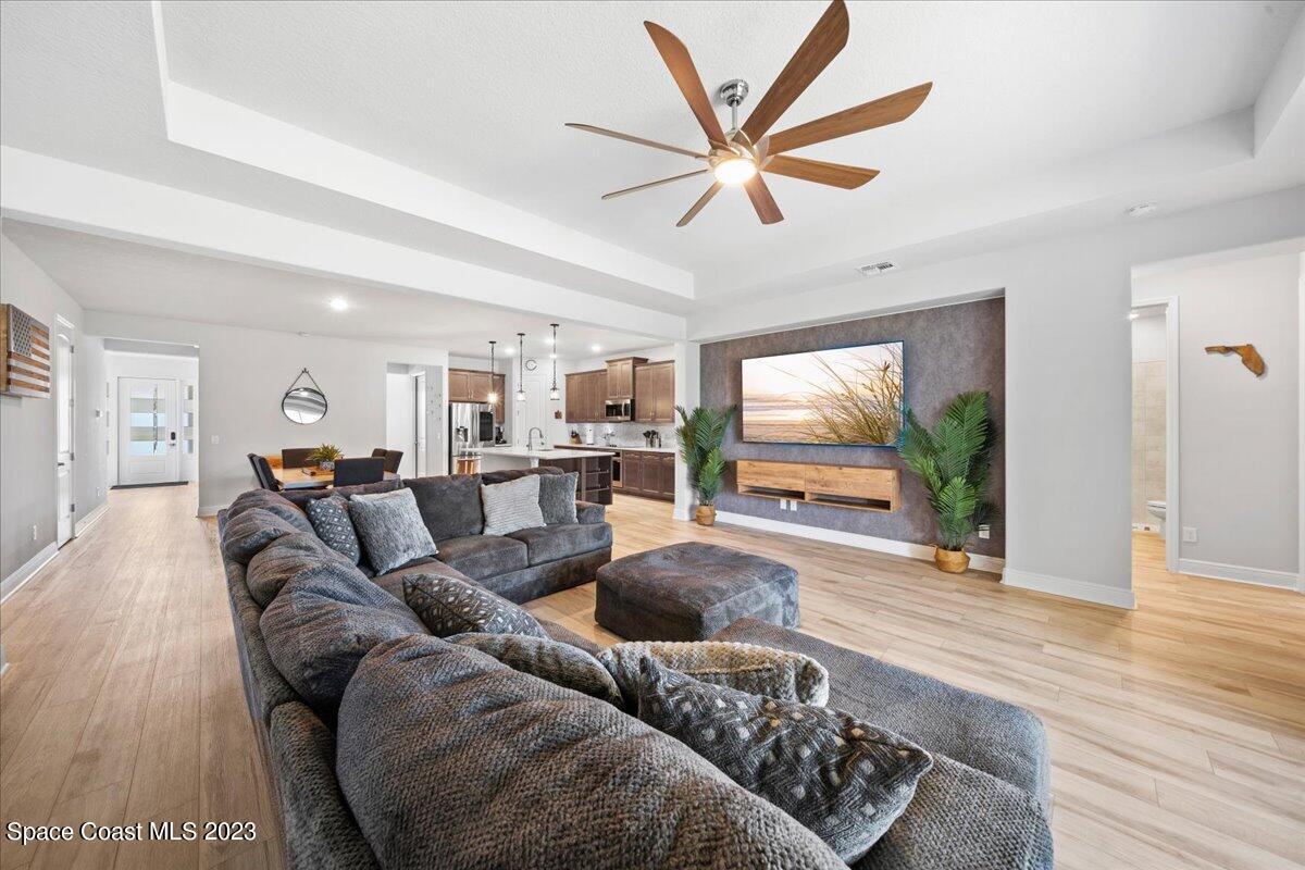 1582 Killian Drive Palm Bay, FL 32905 - Photo 9 of 37 a living room with furniture and a flat screen tv