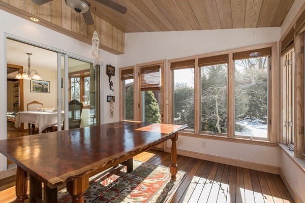 40 Crescent Road Hamilton, MA 01982 - Photo 10 of 28 a dining room with wooden floor and a floor to ceiling window