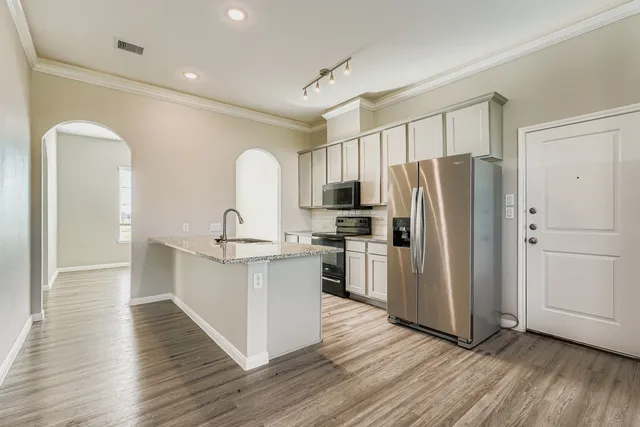 a kitchen with a refrigerator and a sink