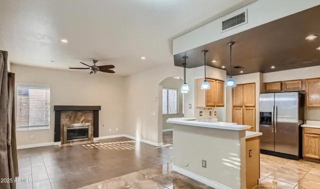 a kitchen with stainless steel appliances a refrigerator and a stove top oven