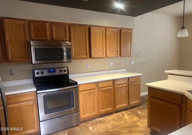 a kitchen with sink a microwave and cabinets