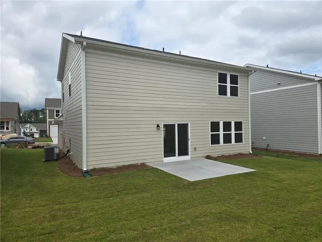 a backyard of a house with yard and barbeque oven