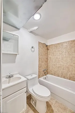 a view of a hallway with bathroom and bathroom