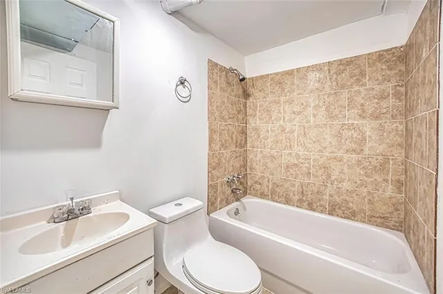 a kitchen with a refrigerator and a sink