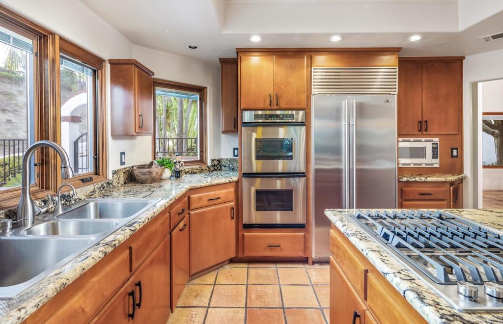 2202 Mountain Vista Drive Encinitas, CA 92024 - Photo 11 of 28 a kitchen with stainless steel appliances granite countertop a stove a sink and a refrigerator