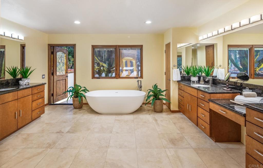 2202 Mountain Vista Drive Encinitas, CA 92024 - Photo 17 of 28 a spacious bathroom with a tub a sink and glass door