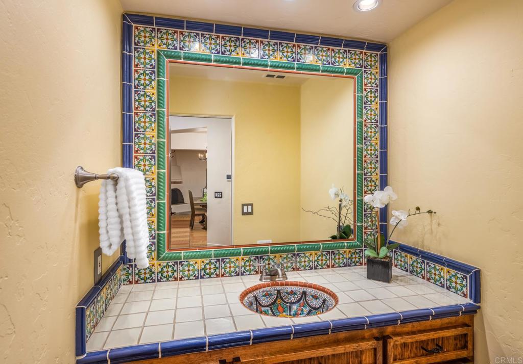 2202 Mountain Vista Drive Encinitas, CA 92024 - Photo 19 of 28 a bathroom with a sink and a mirror