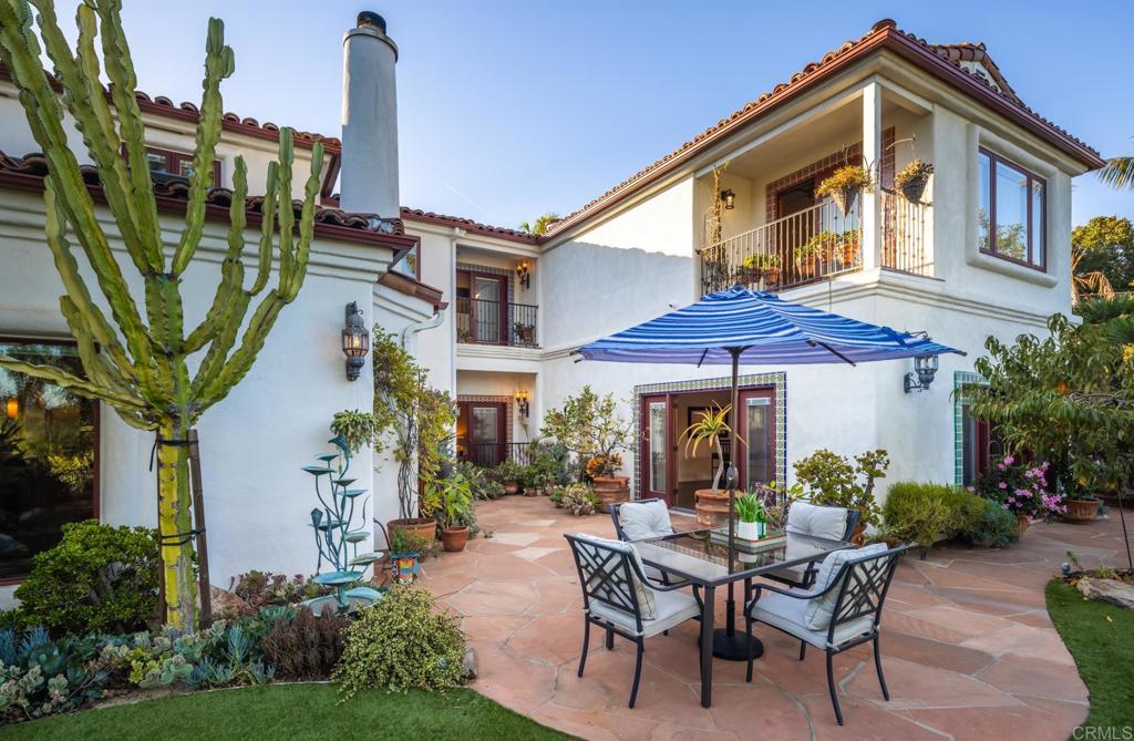 2202 Mountain Vista Drive Encinitas, CA 92024 - Photo 3 of 28 a patio with a table and chairs and potted plants