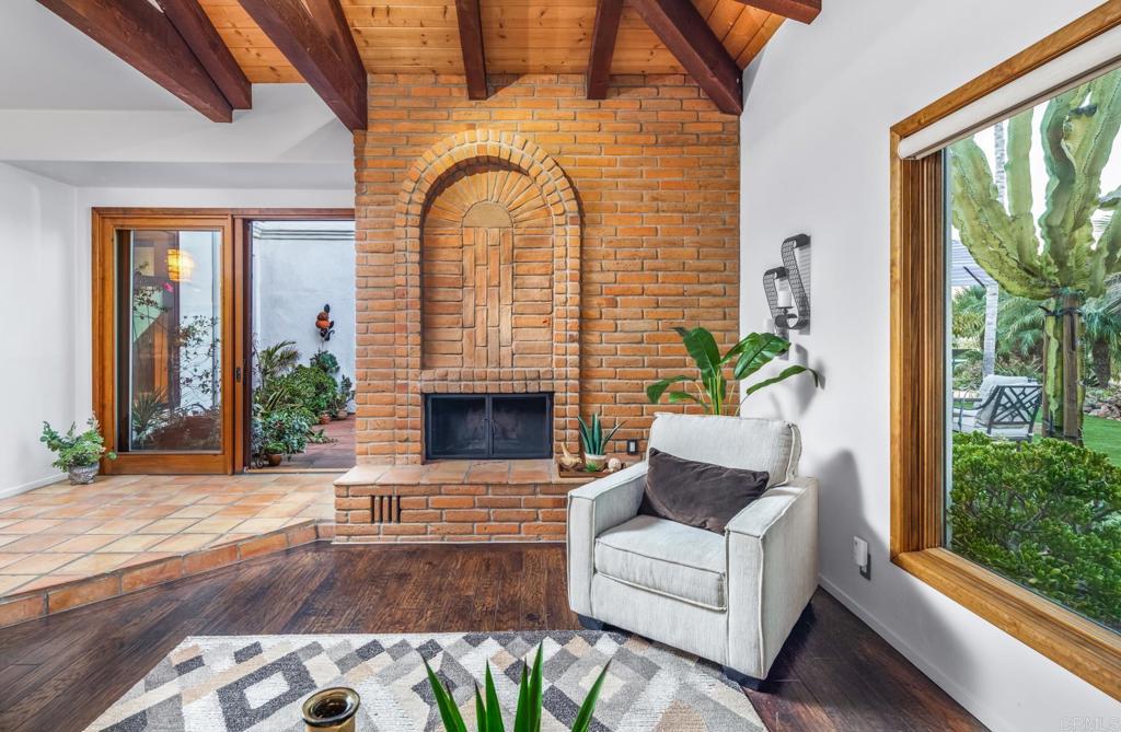 2202 Mountain Vista Drive Encinitas, CA 92024 - Photo 5 of 28 a living room with furniture a fireplace and a potted plant