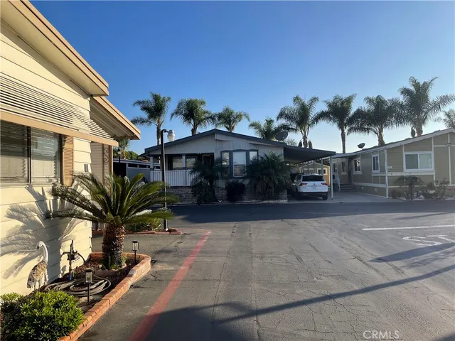 a living room with furniture a flat screen tv and a chandelier