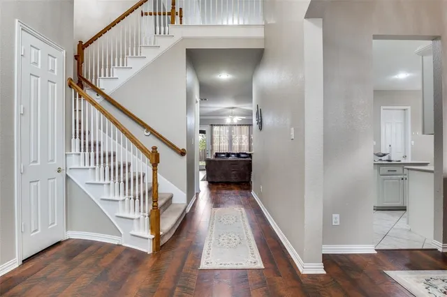 a view of entryway and hall with wooden floor