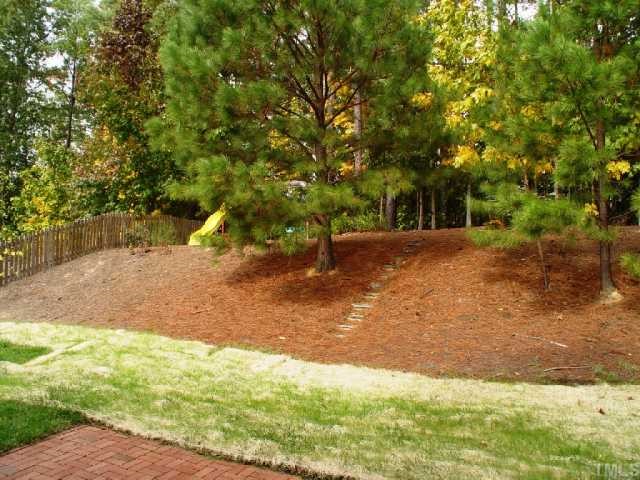 1509 Patterson Grove Road Apex, NC 27502 - Photo 10 of 12 Back yard has "tiered" feeling with a raised area for play as well as a level area near the patio and deck.