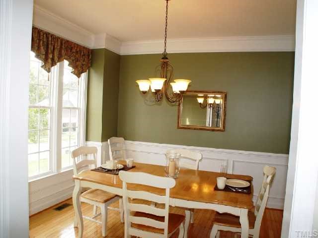 1509 Patterson Grove Road Apex, NC 27502 - Photo 2 of 12 Dining with extra moldings, hardwood floors and lovely boxed bay
