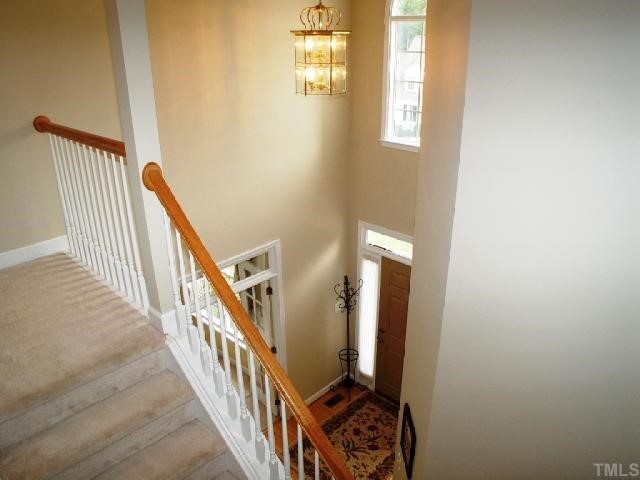 1509 Patterson Grove Road Apex, NC 27502 - Photo 4 of 12 A view of the 2 story foyer, paladian window, transoms at formals and lovely turned staircase.