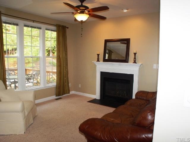 1509 Patterson Grove Road Apex, NC 27502 - Photo 12 of 12 Nice windows along back of house as well as open floorplan make this an inviting family room space. Gas logs for chilly nights paddle fan for warm days.