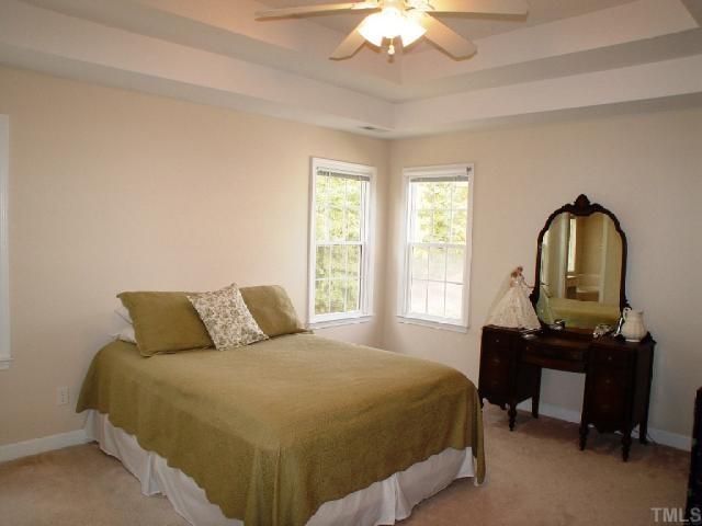 1509 Patterson Grove Road Apex, NC 27502 - Photo 7 of 12 Double boxed trey ceiling and nice windows create a voluminous feeling in the master suite. Nice walk in closet accommodates for wardrobes nicely.