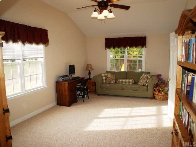 1509 Patterson Grove Road Apex, NC 27502 - Photo 9 of 12 This 4th Bedroom/Bonus room has a built-in shelving unit as well as a great walk in closet. Neat nooks are created by the roof architecture. A vaulted ceiling and nice paddle fan create a spacious and friendly atmosphere for just about any activity.