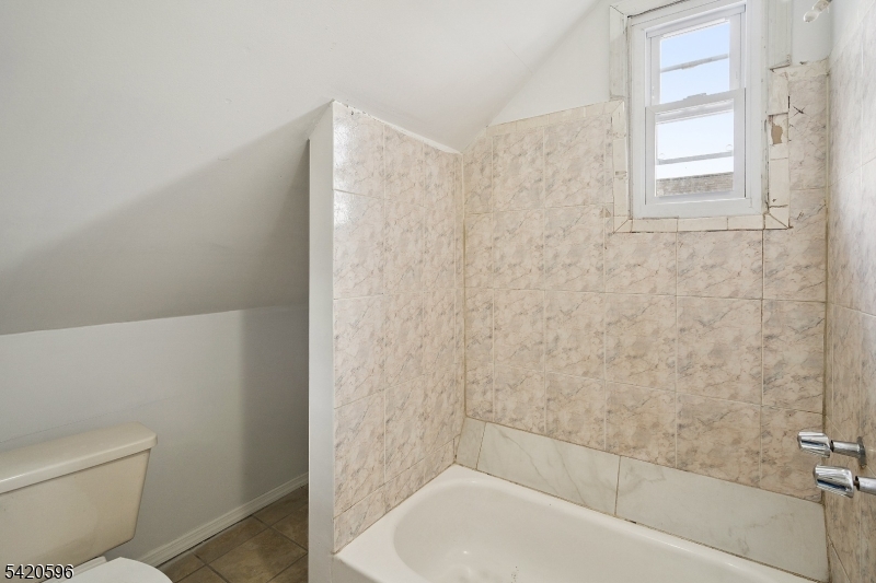 904 2nd Avenue, Unit 2 Elizabeth, NJ 07201 - Photo 1 of 19 a bathroom with a bathtub and a toilet
