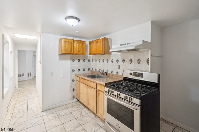 904 2nd Avenue, Unit 2 Elizabeth, NJ 07201 - Photo 13 of 19 a kitchen with granite countertop a stove and a sink
