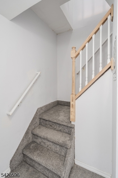 904 2nd Avenue, Unit 2 Elizabeth, NJ 07201 - Photo 16 of 19 a view of staircase with white walls and white door