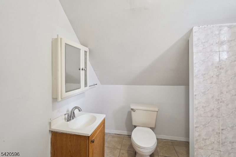 904 2nd Avenue, Unit 2 Elizabeth, NJ 07201 - Photo 2 of 19 a bathroom with a toilet sink and mirror