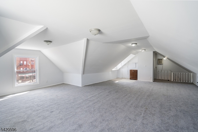 904 2nd Avenue, Unit 2 Elizabeth, NJ 07201 - Photo 3 of 19 an empty room with windows and fireplace