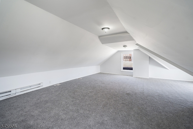 904 2nd Avenue, Unit 2 Elizabeth, NJ 07201 - Photo 4 of 19 an empty room with a empty space and windows