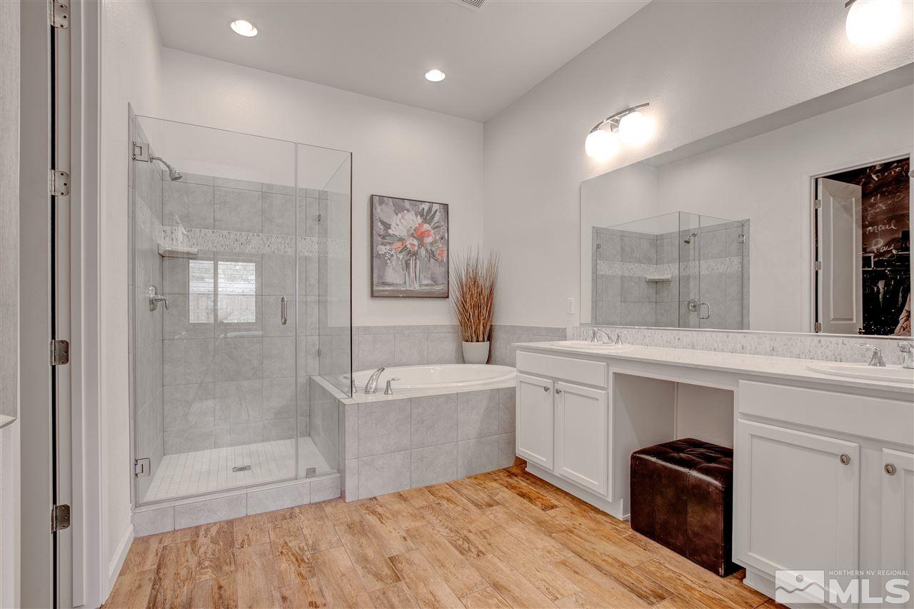 3175 Show Jumper Lane Reno, NV 89521 - Photo 15 of 40 a spacious bathroom with a bathtub sink and mirror