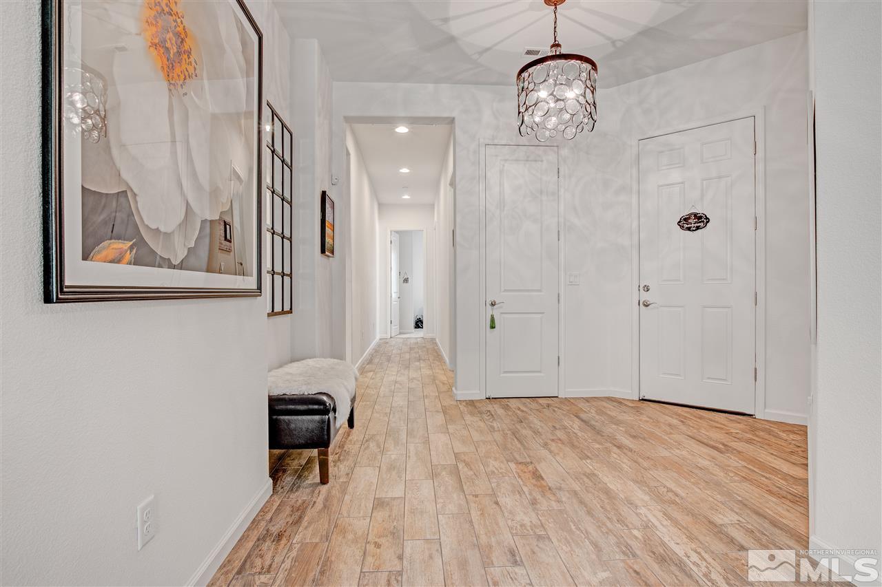 3175 Show Jumper Lane Reno, NV 89521 - Photo 16 of 40 a view of a hallway with wooden floor