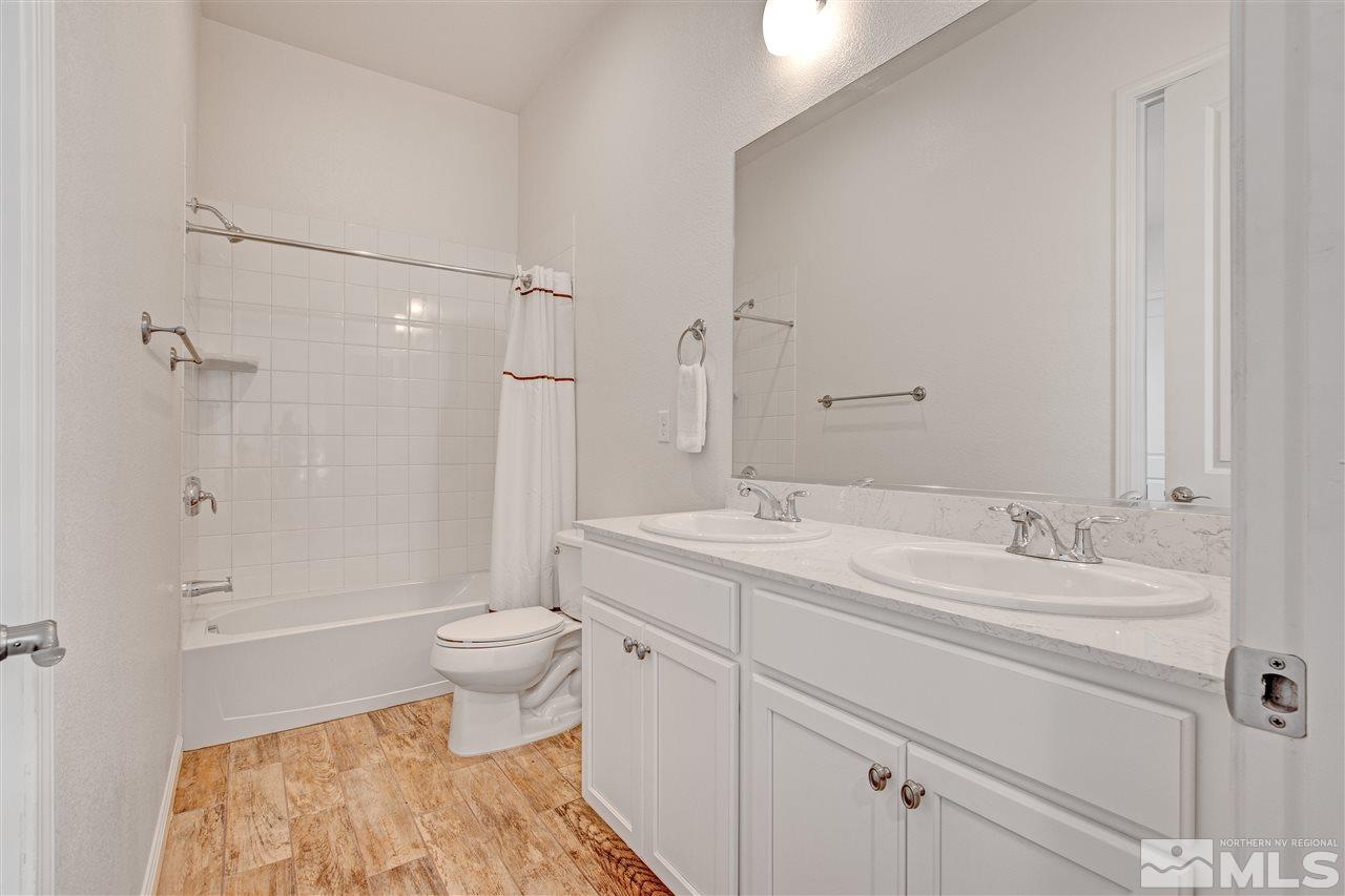 3175 Show Jumper Lane Reno, NV 89521 - Photo 21 of 40 a spacious bathroom with a granite countertop sink a toilet and a shower