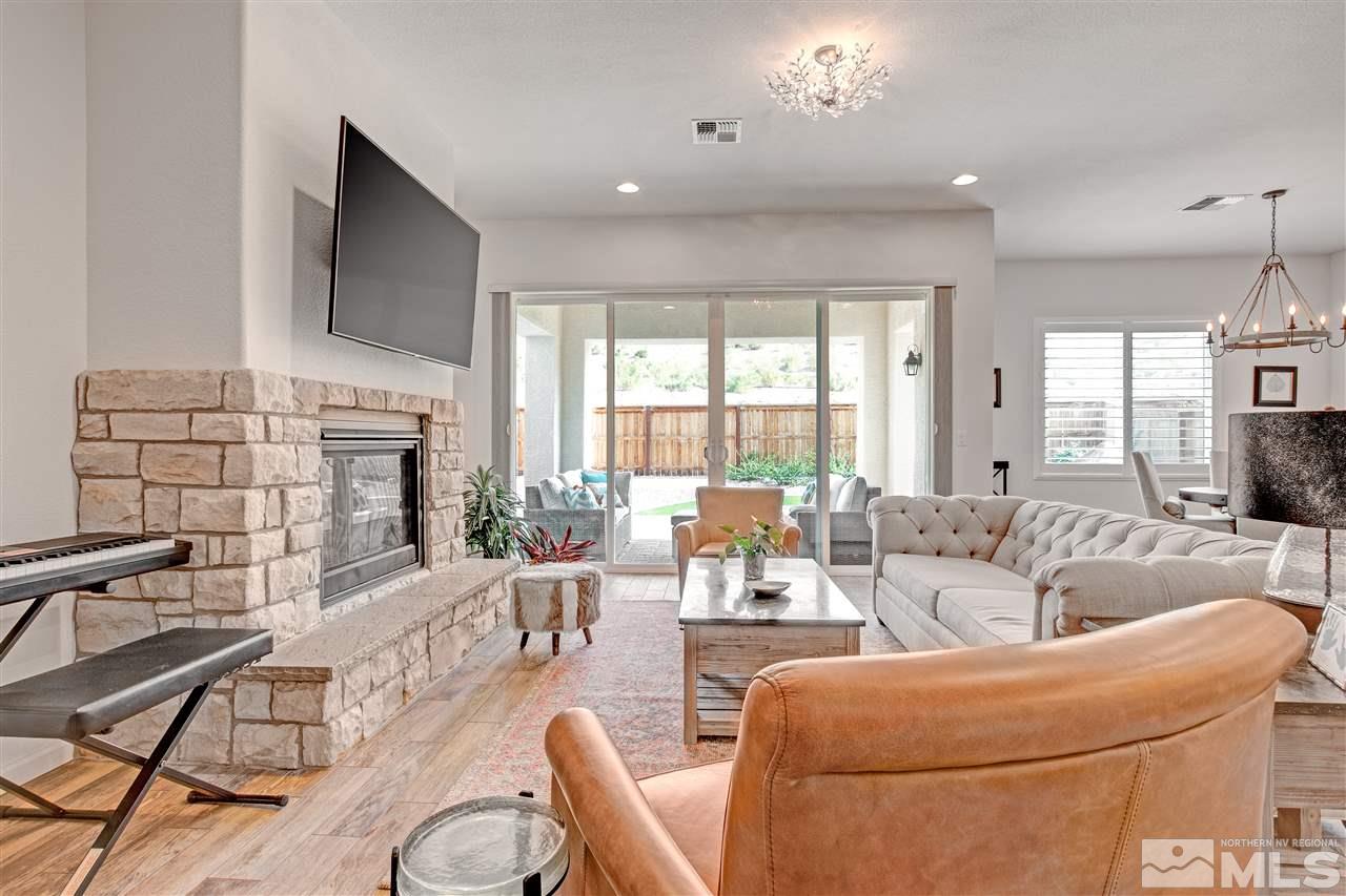 3175 Show Jumper Lane Reno, NV 89521 - Photo 6 of 40 a living room with fireplace furniture and a large window