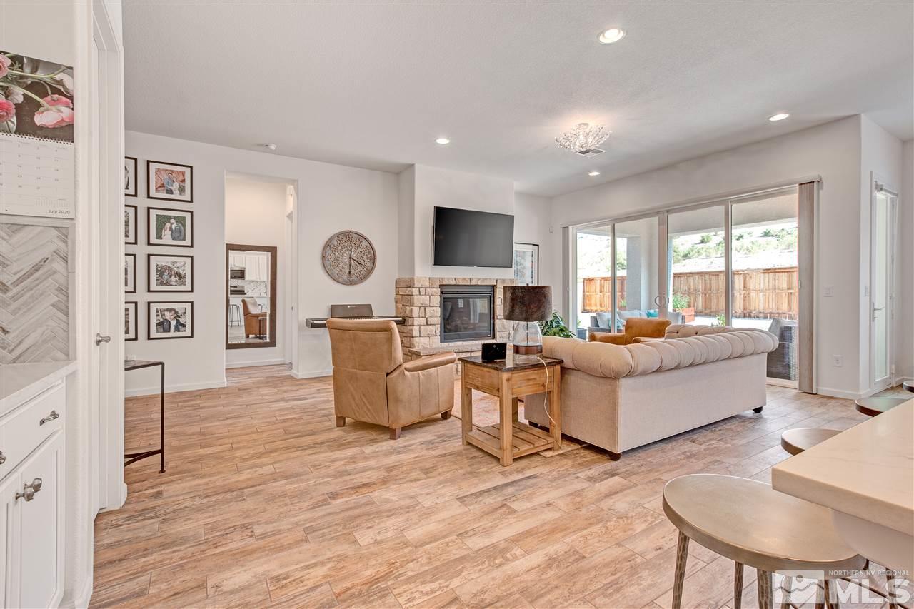 3175 Show Jumper Lane Reno, NV 89521 - Photo 7 of 40 a living room with fireplace furniture and a wooden floor