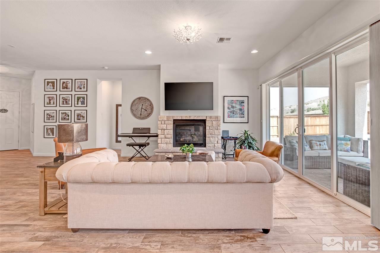 3175 Show Jumper Lane Reno, NV 89521 - Photo 8 of 40 a living room with fireplace furniture and a flat screen tv