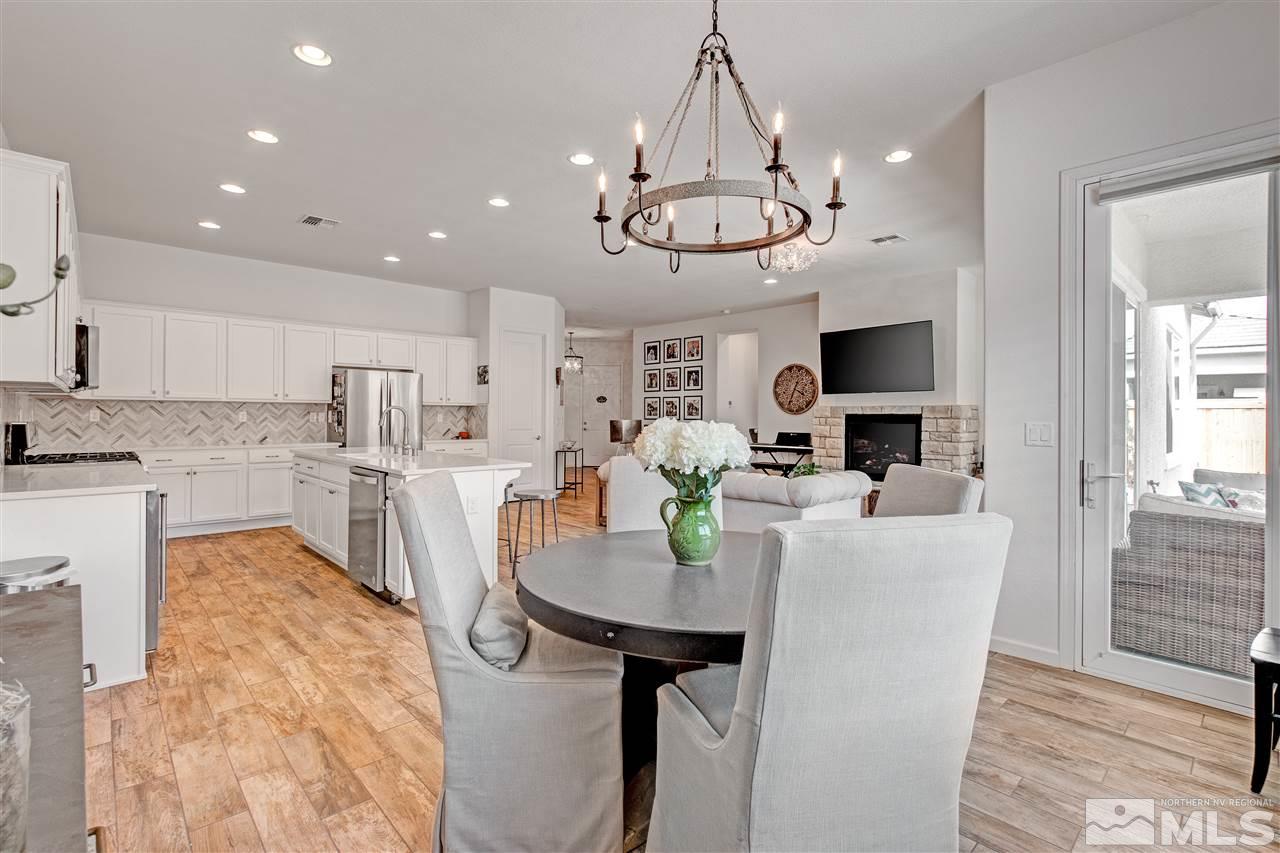 3175 Show Jumper Lane Reno, NV 89521 - Photo 9 of 40 a view of a dining room with furniture a chandelier and wooden floor