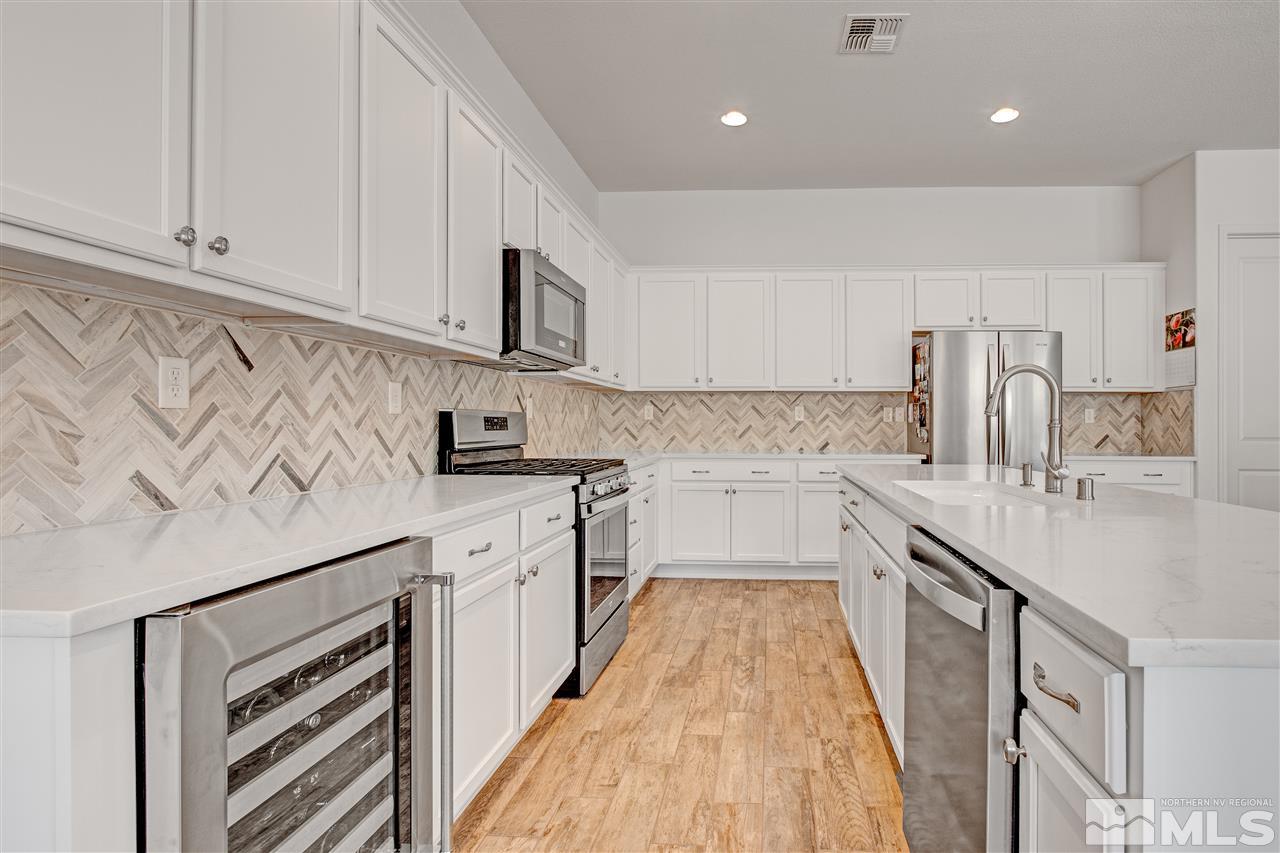 3175 Show Jumper Lane Reno, NV 89521 - Photo 10 of 40 a kitchen with granite countertop white cabinets and white appliances