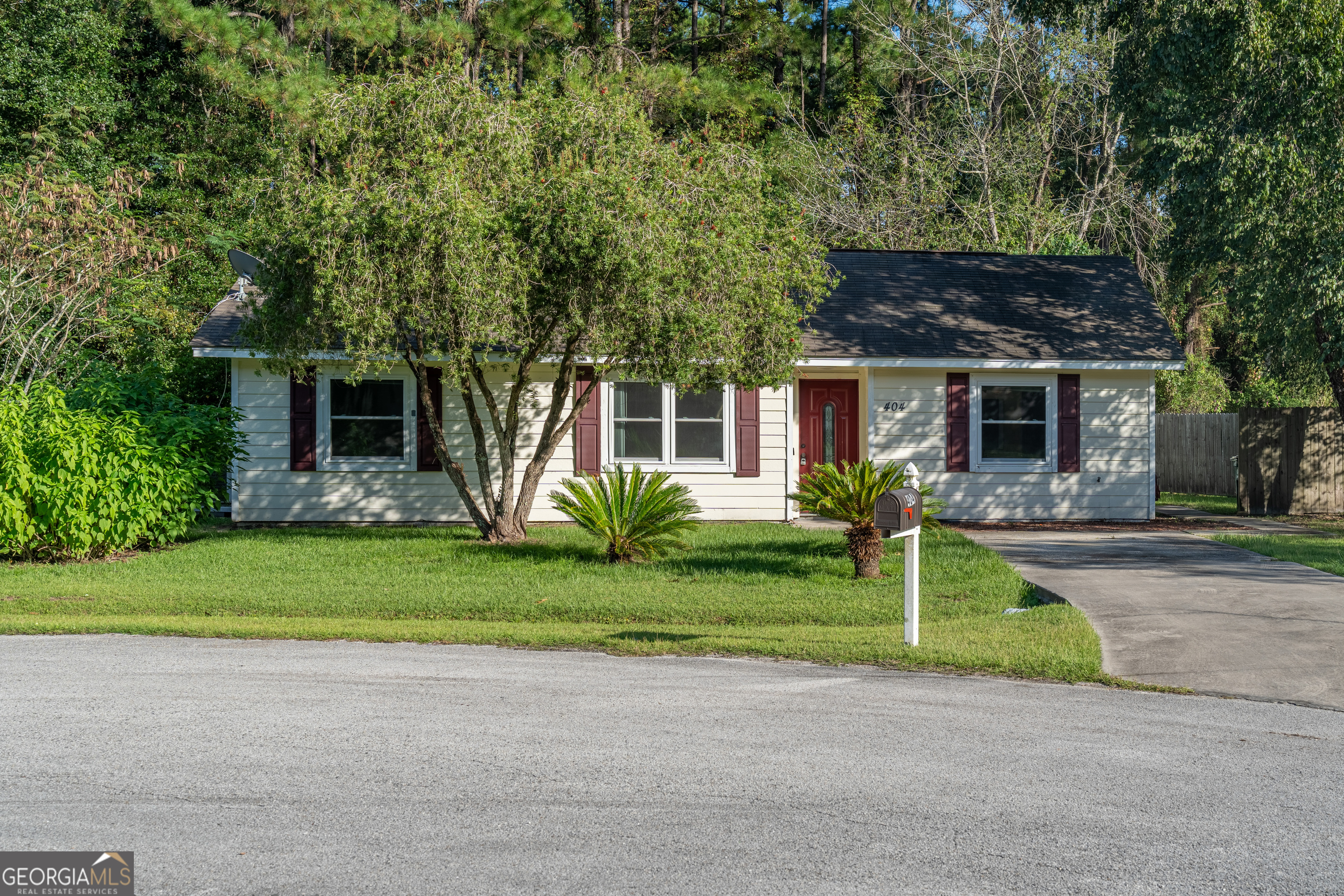 404 Potomac Court St. Marys, GA 31558 - Photo 1 of 30 a front view of a house with plants and garden