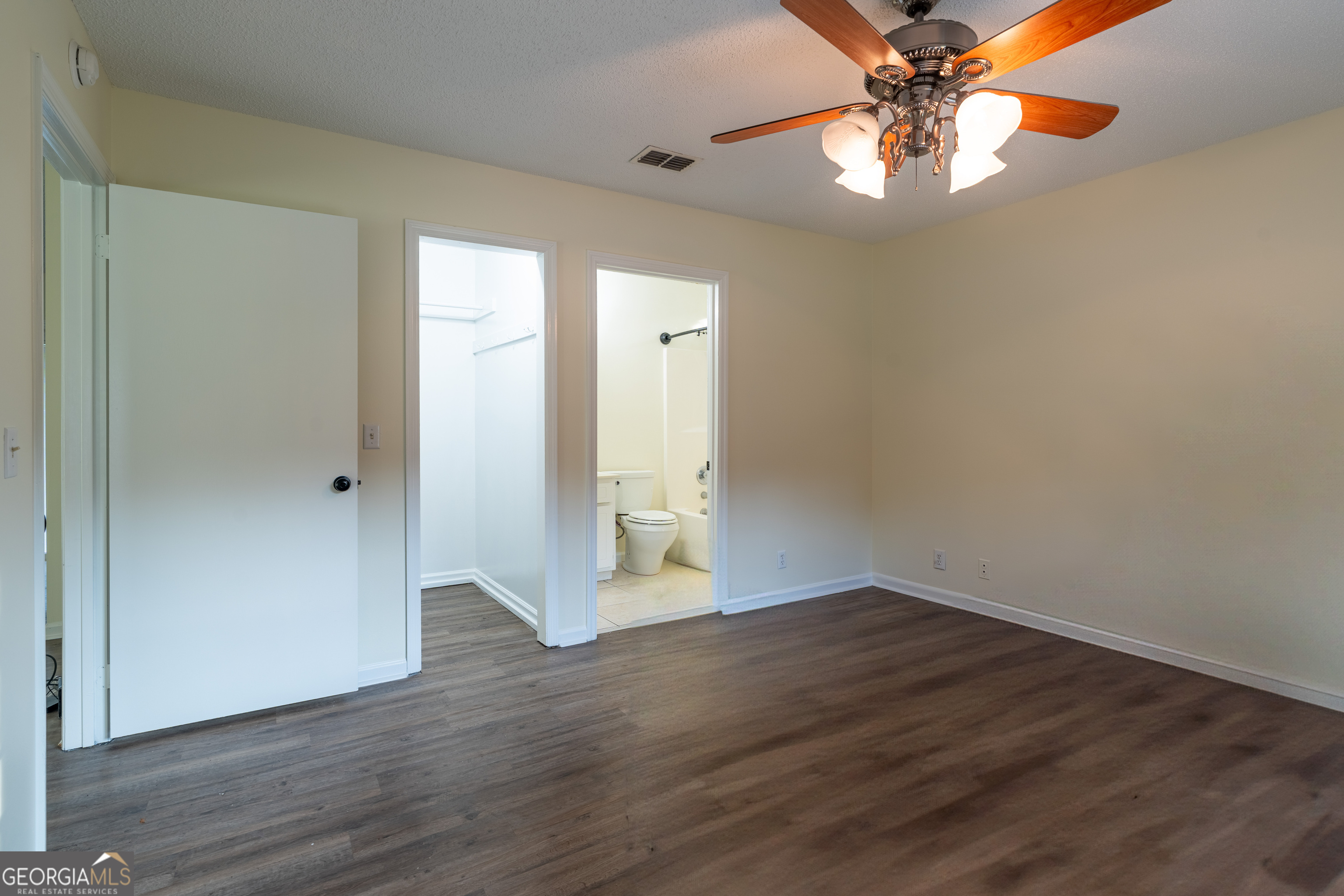 404 Potomac Court St. Marys, GA 31558 - Photo 16 of 30 an empty room with wooden floor chandelier fan and closet area
