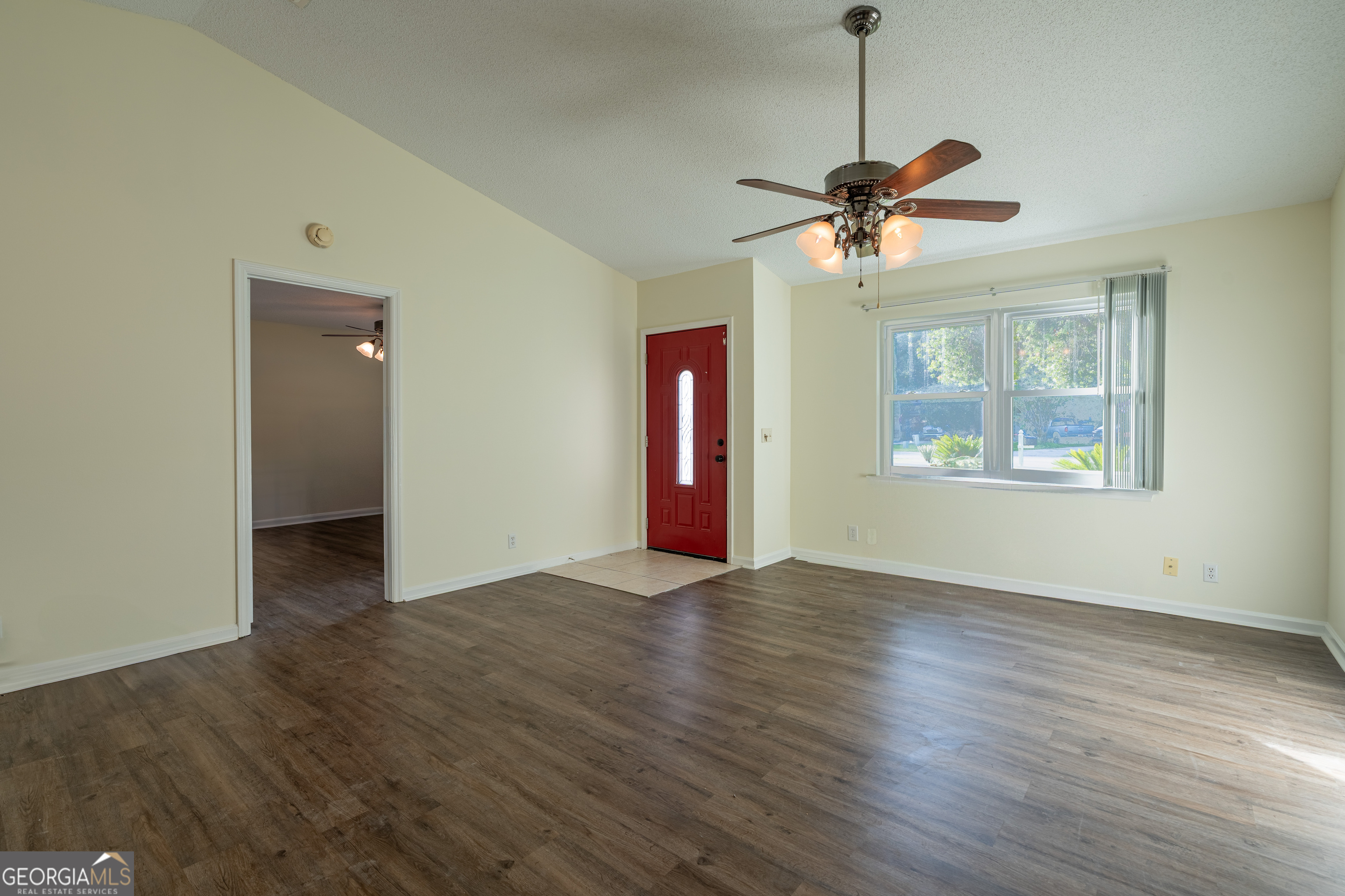 404 Potomac Court St. Marys, GA 31558 - Photo 9 of 30 a view of an empty room with window and wooden floor