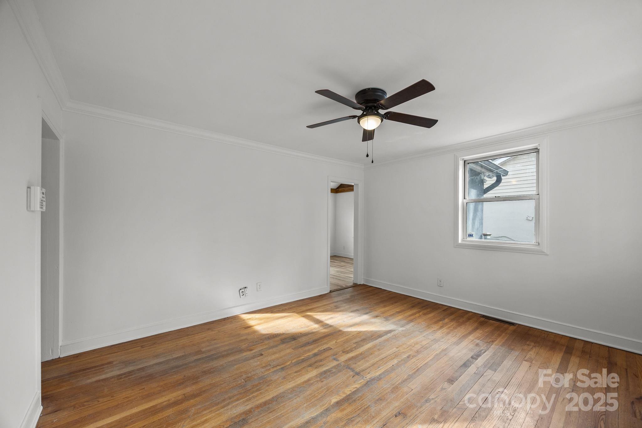 175 Chatham Road Asheville, NC 28804 - Photo 13 of 48 a view of empty room with wooden floor and fan
