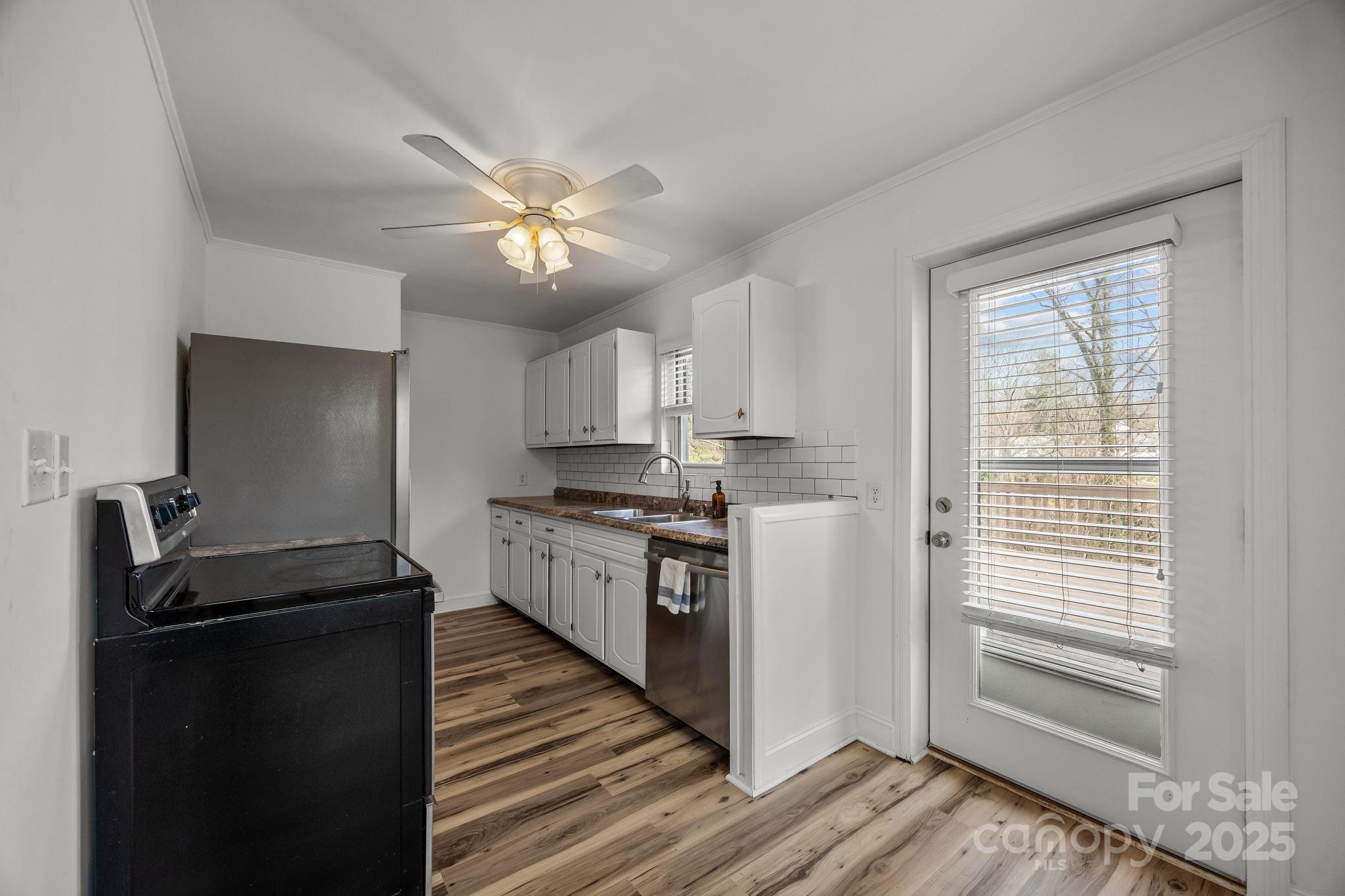 175 Chatham Road Asheville, NC 28804 - Photo 15 of 48 a kitchen with stainless steel appliances granite countertop a sink and a refrigerator