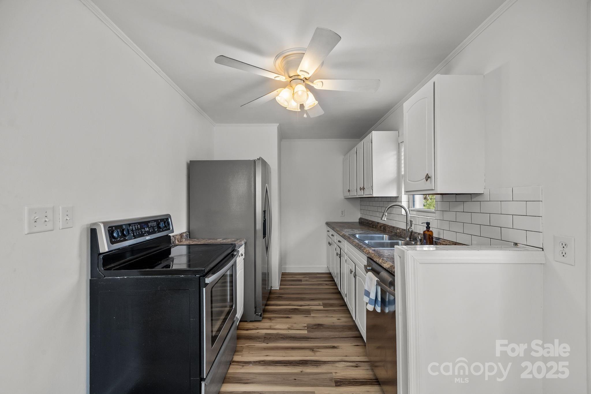 175 Chatham Road Asheville, NC 28804 - Photo 17 of 48 a kitchen with a sink and a refrigerator