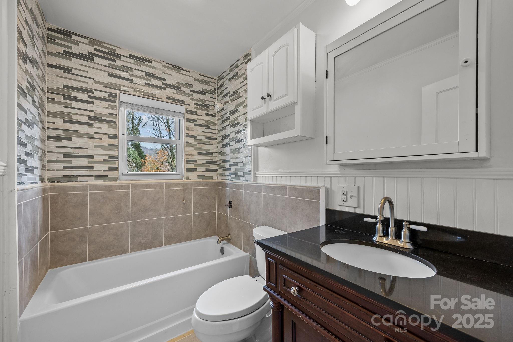 175 Chatham Road Asheville, NC 28804 - Photo 29 of 48 a bathroom with a granite countertop bathtub sink vanity mirror and toilet