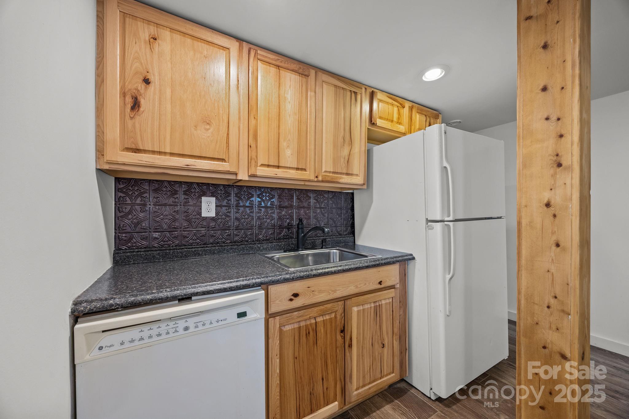 175 Chatham Road Asheville, NC 28804 - Photo 33 of 48 a kitchen with stainless steel appliances granite countertop a refrigerator sink and cabinets