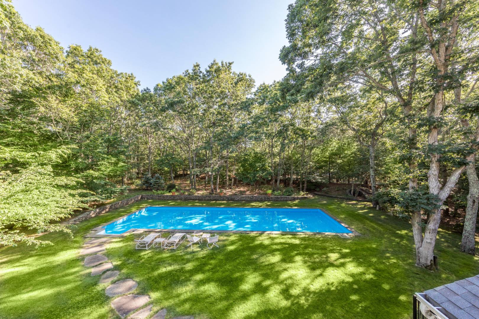 114 Neck Path East Hampton, NY 11937 - Photo 18 of 20 a view of yard with swimming pool and outdoor seating