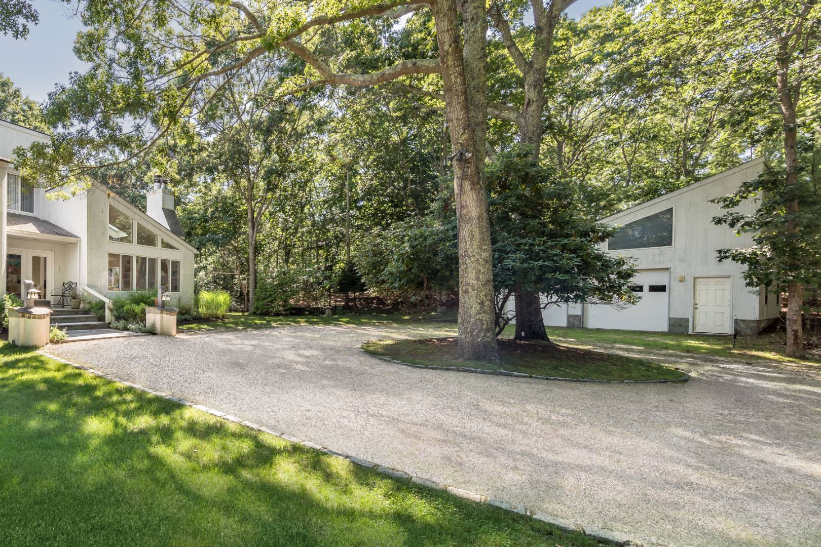 114 Neck Path East Hampton, NY 11937 - Photo 3 of 20 a view of a house with a yard and garage