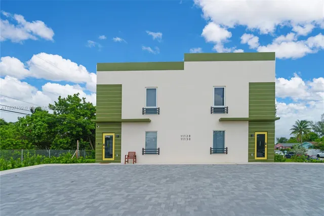 a front view of a house with a yard and a garage