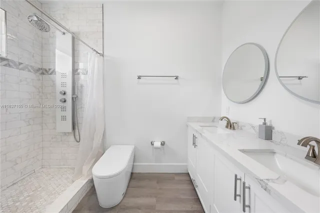 a bathroom with a toilet sink and shower